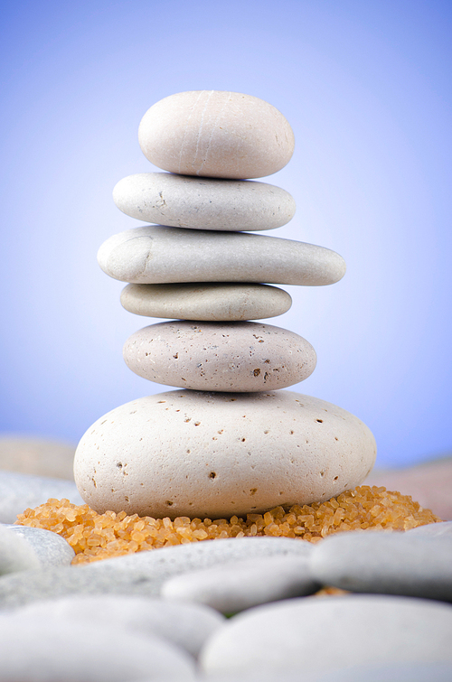 Balanced pebbles with colour background