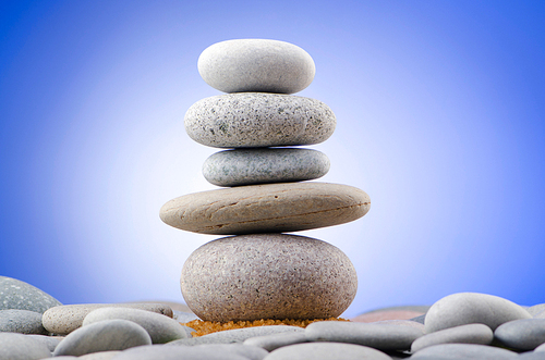 Balanced pebbles with colour background