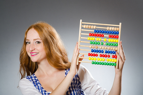 Young woman with abacus in school education concept