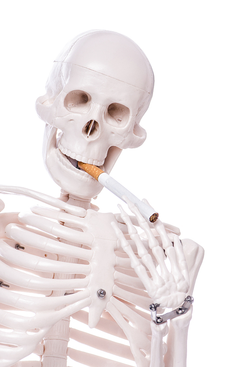 Skeleton smoking cigarette isolated on white