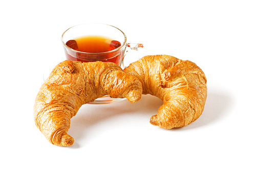 Breakfast concept - croissant and tea isolated on white