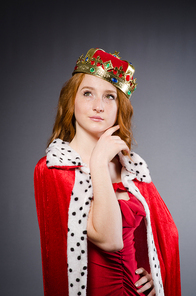 Queen in red dress in studio