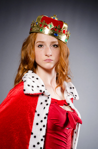 Queen in red dress in studio