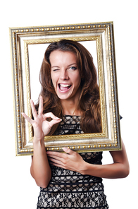 Young woman with picture frame on white