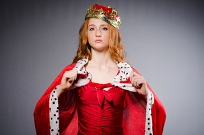 Queen in red dress in studio