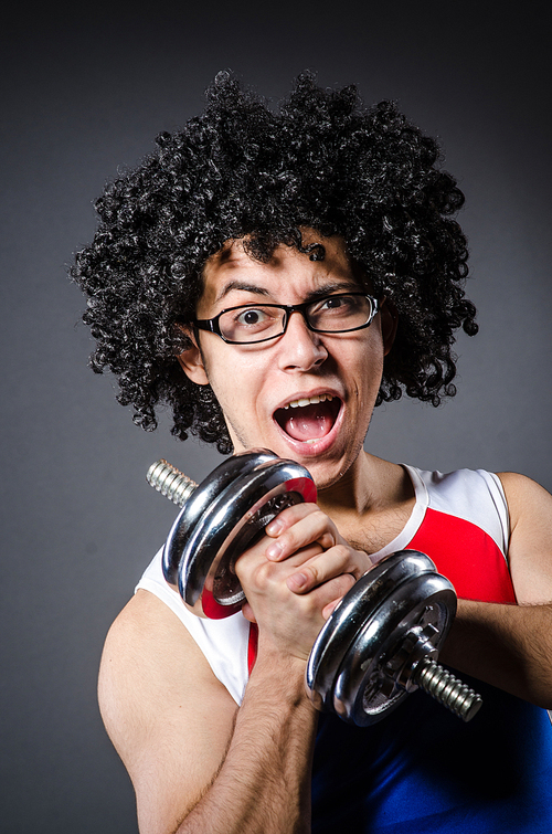 Funny man exercising with dumbbells