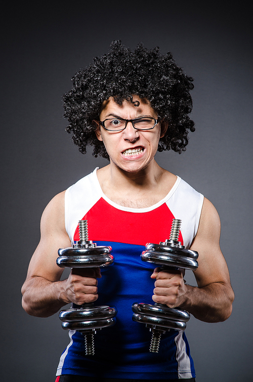 Funny man exercising with dumbbells