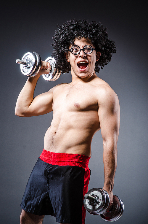 Funny man exercising with dumbbells