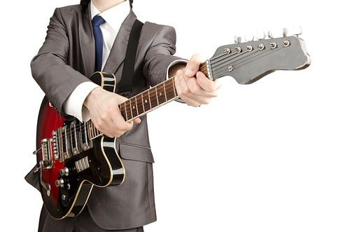 Young guitar player isolated on white