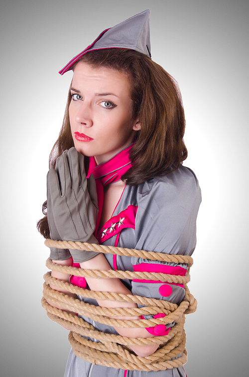 Female stewardess tied with rope