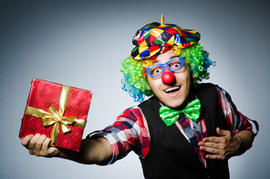 Funny clown with red giftbox