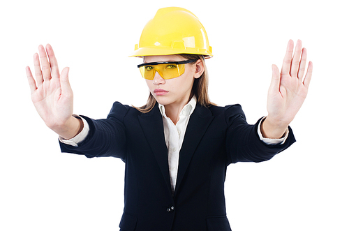 Young businesswoman with hard hat on white