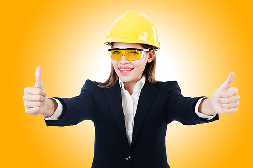 Young businesswoman with hard hat on white