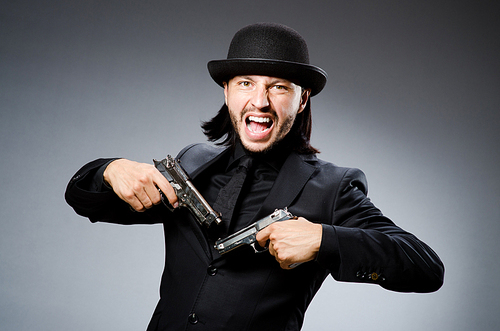 Man wearing vintage hat with gun