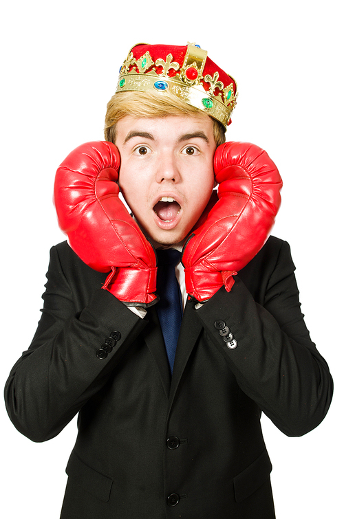 Funny businessman with crown and boxing gloves