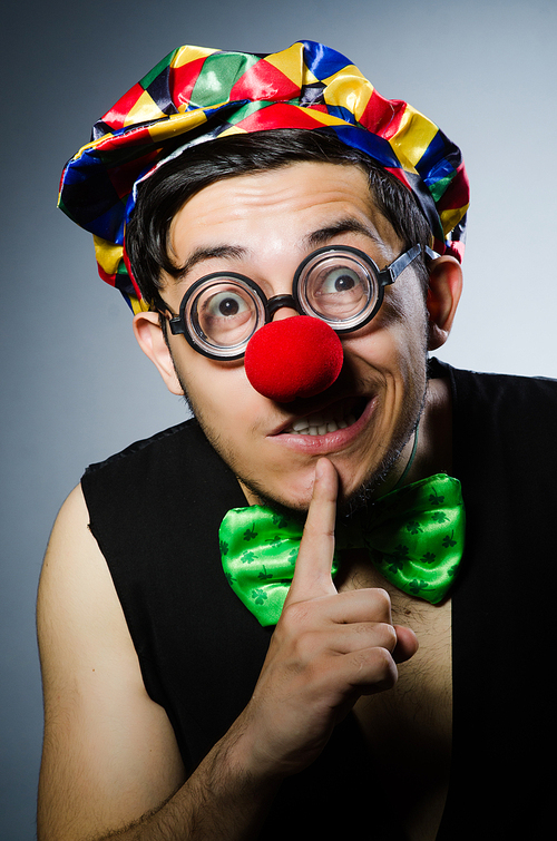 Funny clown against the dark background