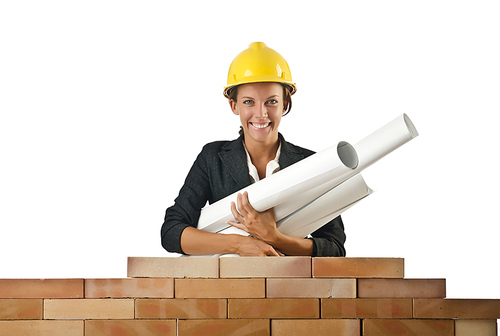 Businesswoman with drawings near brick wall