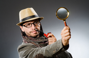 Funny detective with smoking pipe and magnifying glass