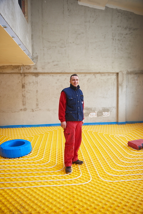 grouo of workera installing underfloor heating and colling in modern home