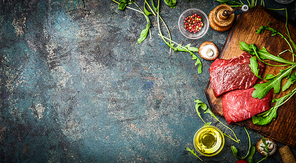 Raw Beef steak and fresh ingredients for cooking on rustic background, top view, banner.  Healthy and diet food concept.