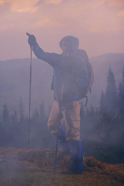 advanture man with backpack hiking on mountain forest