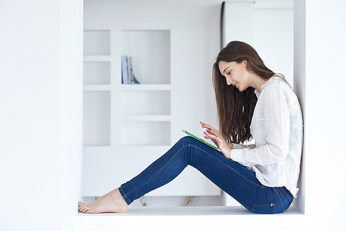 woman at home using tablet computer