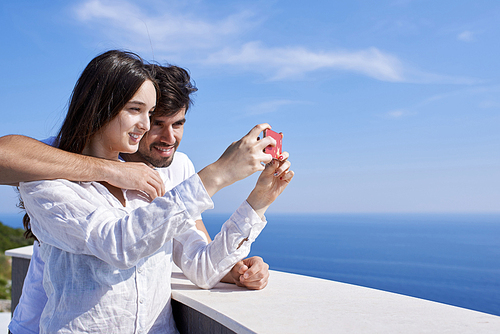 happy young couple taking selfie with cell phone