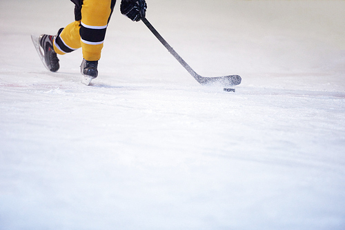 ice hockey player in action kicking with stick