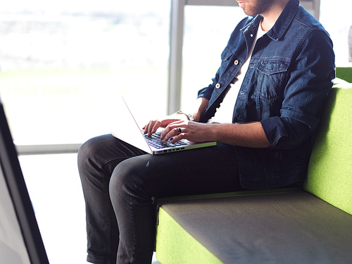 student working on laptop computer at university school modern interior