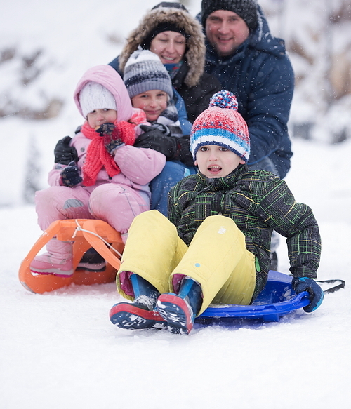 group of children having fun and play together in fresh snow on winter vacation