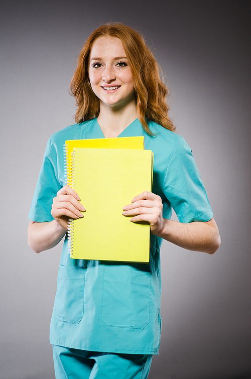 Young woman doctor with book