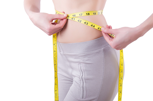 Young girl with centimeter in dieting concept