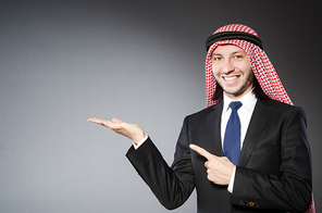 Arab businessman handing hands  againt grey background