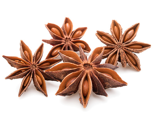 Star anise spice fruits and seeds isolated on white closeup