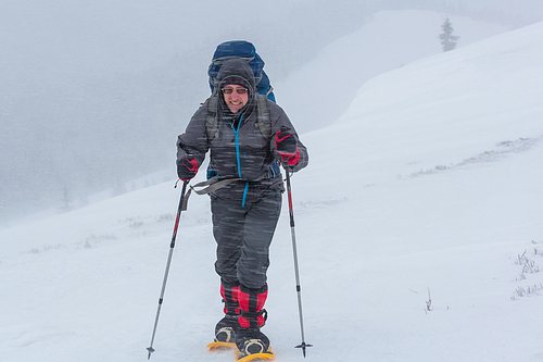 Hiker with snowshoes in winter