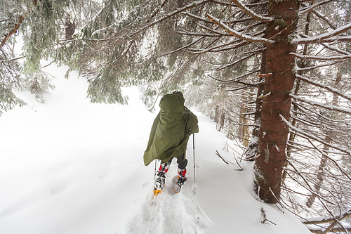 Hiker with snowshoes in winter