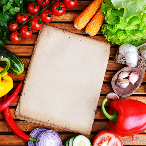 fresh vegetables and olive oil on wooden background