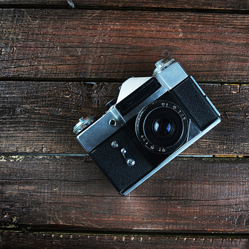 old camera on dark wooden background