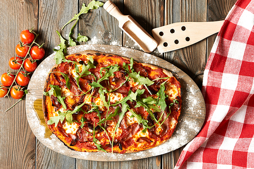 Home made pizza on wooden rustic table