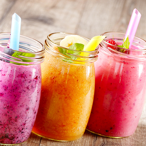 Assorted fruit shakes on white table. Smoothie concept