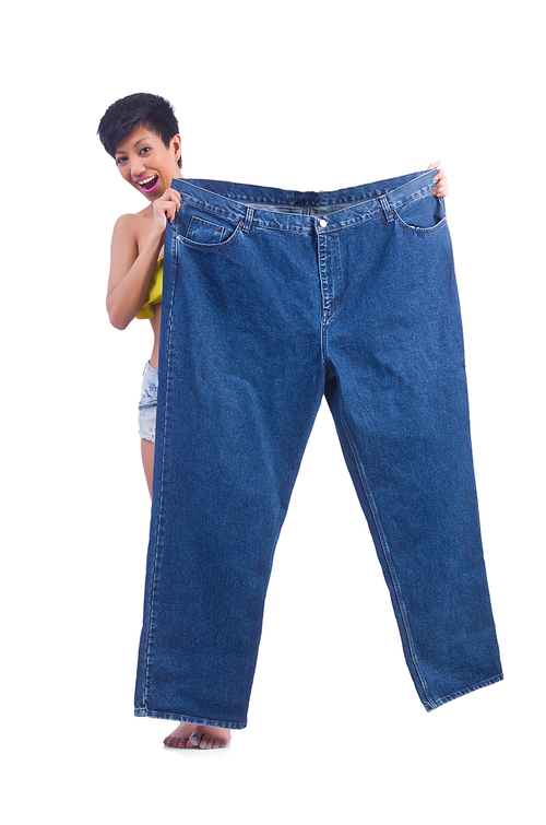 Woman in dieting concept with big jeans