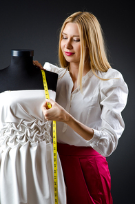 Woman tailor working on dress