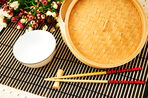 Chopsticks and bowl on the bamboo mat