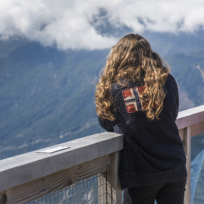 Rear view of a girl looking at valley, Coast Mountains, Squamish, British Columbia, Canada