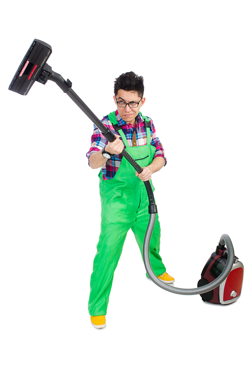 Funny man in green coveralls vacuum cleaning