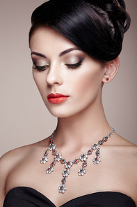 Fashion portrait of young beautiful woman with jewelry. Brunette girl. Perfect make-up.  Beauty style woman with diamond accessories
