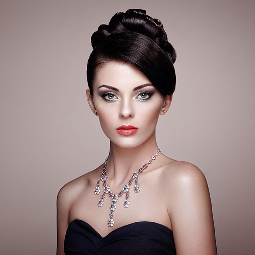 Fashion portrait of young beautiful woman with jewelry. Brunette girl. Perfect make-up.  Beauty style woman with diamond accessories