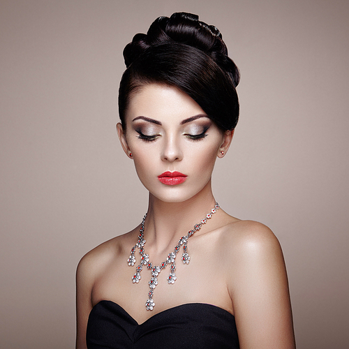 Fashion portrait of young beautiful woman with jewelry. Brunette girl. Perfect make-up.  Beauty style woman with diamond accessories