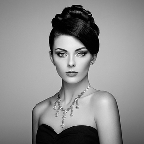 Fashion portrait of young beautiful woman with jewelry. Brunette girl. Perfect make-up.  Beauty style woman with diamond accessories. Black and White
