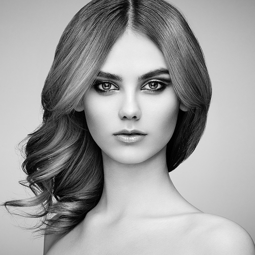 Portrait of beautiful sensual woman with elegant hairstyle. Perfect makeup. Beauty fashion. Eyelashes. Lips. Cosmetic Eyeshadow. Black and White